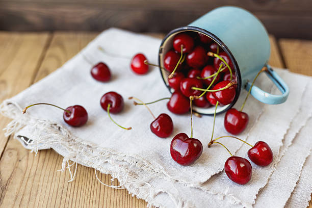 istock Fresh juicy sweet cherries  in old rusty mug. Rustic background 537810180