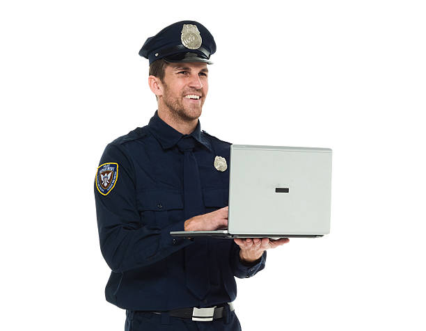 istock Smiling police working on laptop 537811436