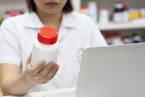 istock Pharmacist holding medication in the pharmacy 537814464
