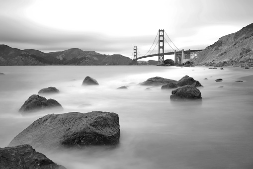 A black and white time exposure of the Golden Gate Bridge shot from Marshall Beach
