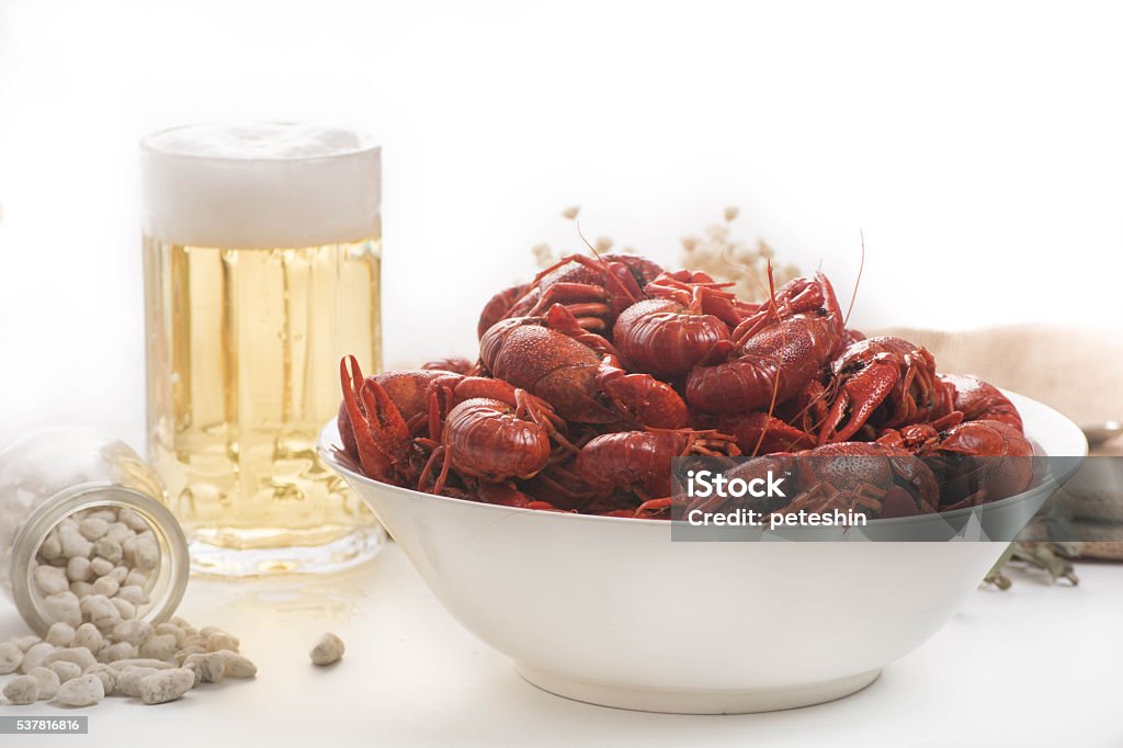 boiled big crawfish on the white surface with a beer plate of boiled crawfish on wooden surface Backgrounds Stock Photo