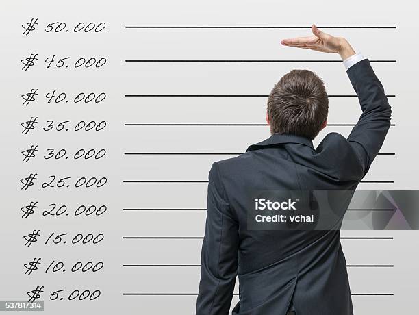 Career Concept Man Is Comparing His Income With Average Wage Stock Photo - Download Image Now