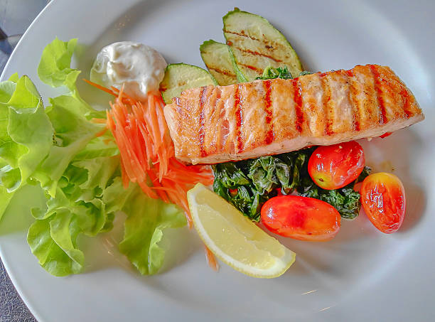Salmon steaks grill served with salad and grilled vegetables