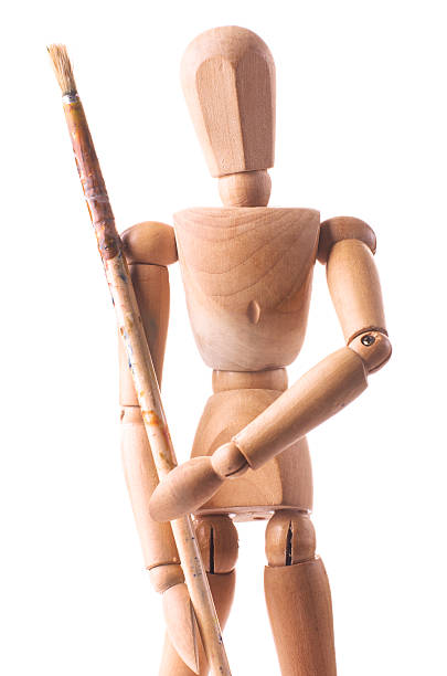 istock wooden mannequin with dirty paint brush 537818579