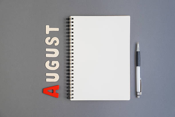 istock Spiral open notebook with pen and August month wording 537819412