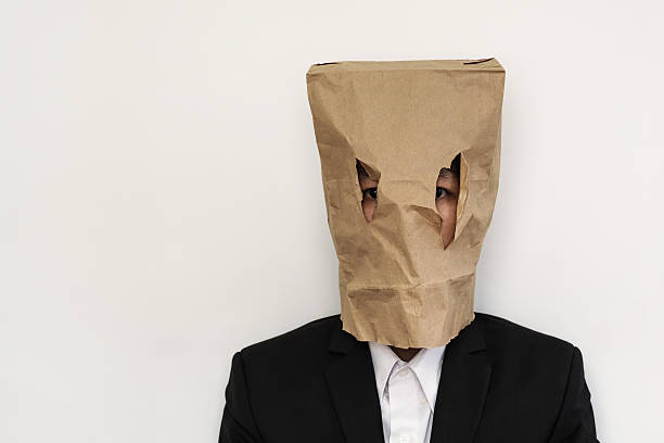 Businessman with brown paper bag on head