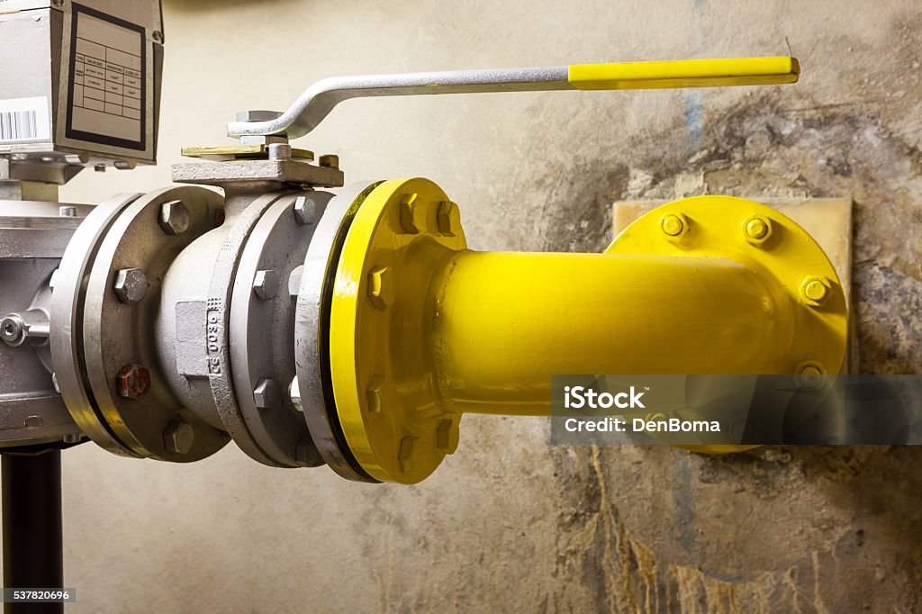 gas shut-off valve in an separate room there is an large gas valve Machine Valve Stock Photo