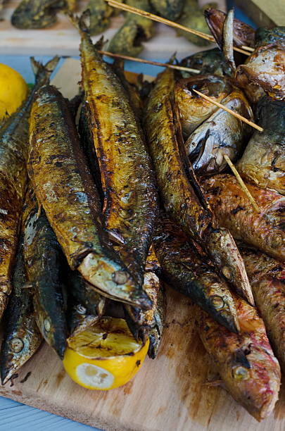 istock Grilled sea fish with lemons and greenery 537821334