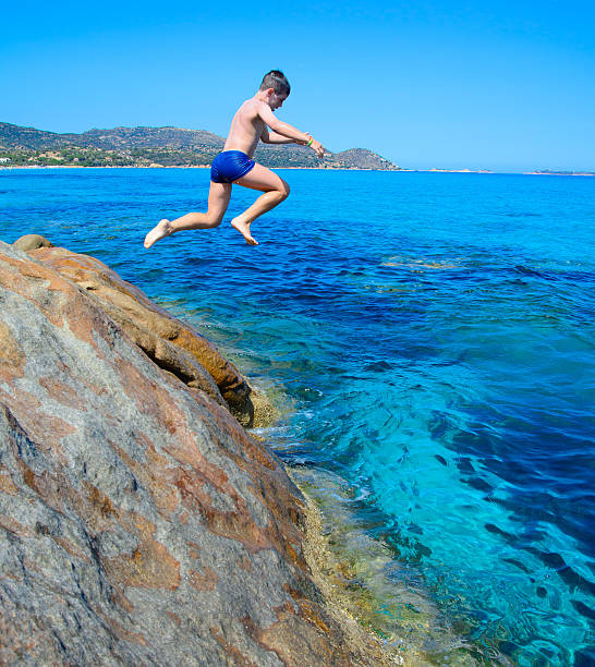 istock Young happy boy having fun on tropical beach 537821569