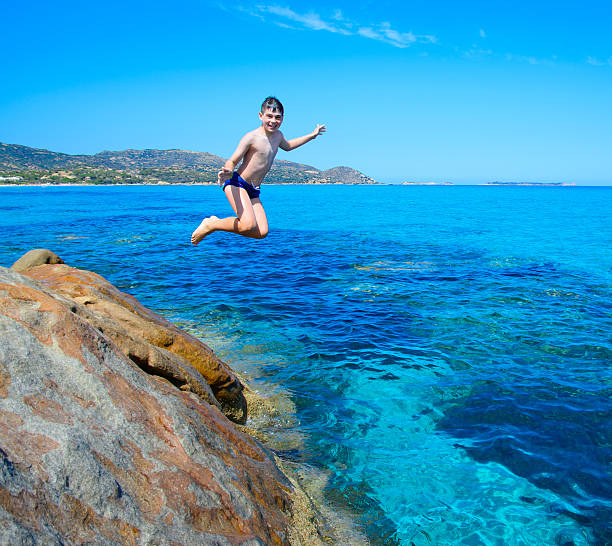 istock Young happy boy having fun on tropical beach 537821579
