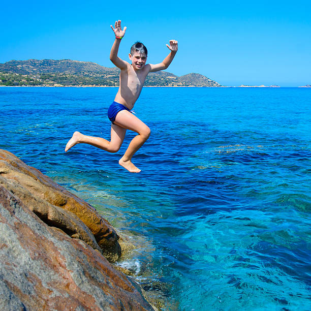 istock Young happy boy having fun on tropical beach 537821589