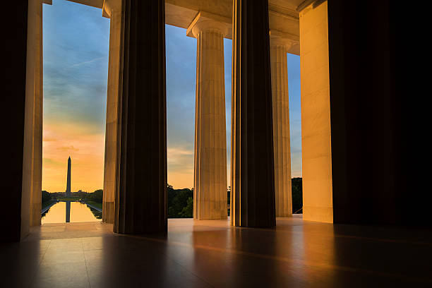Washington Monument from Lincoln Memorial at Sunrise in Washington, DC Early morning summer sunrise as seen from the Lincoln Memorial while looking toward the Washington Monument in Washington, DC. lincoln memorial photos stock pictures, royalty-free photos & images