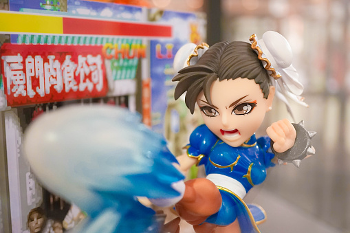 Bangkok, Thailand - MAY 7, 2016 : Portrait of Chun-Li mascot to promote the game in Thailand Toy Expo 2016. She is a character from Street Fighter Game, abstract pixel background