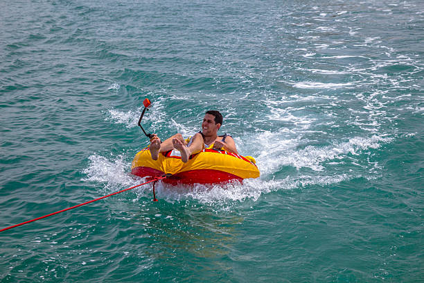 istock Man sitting in inflatable ring in the water 537823736