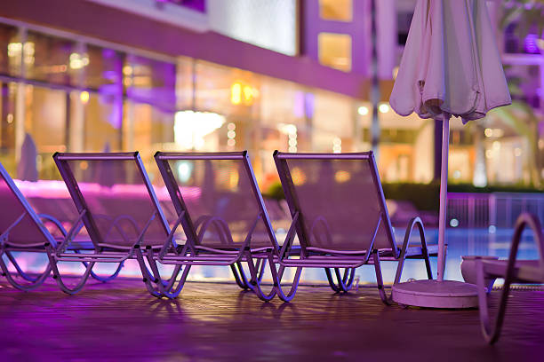 Chaise-longues by the pool in the evening