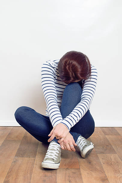 istock Woman Suffering From Depression Sitting On the floor 537826964