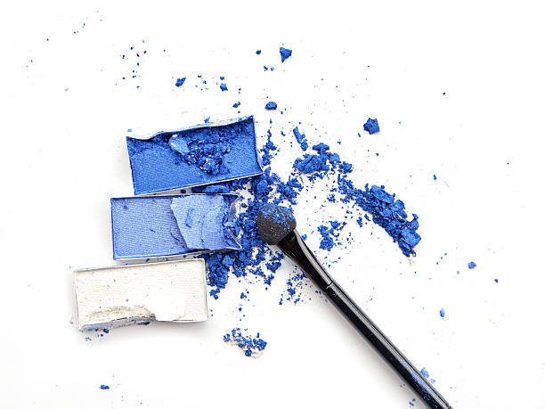 istock Crushed blue eyeshadow with makeup brush on white background 537826988
