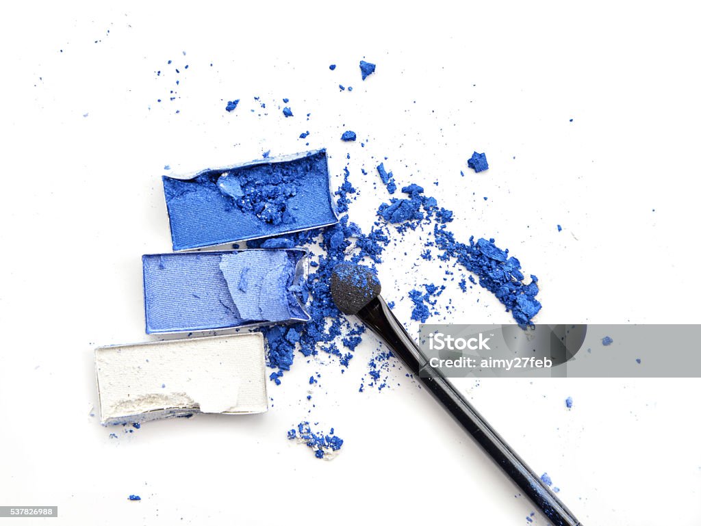 Crushed blue eyeshadow with makeup brush on white background Beauty Product Stock Photo