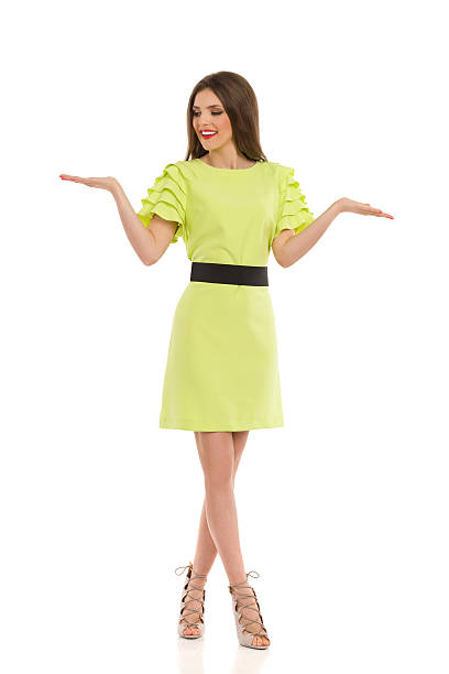 istock Woman In Lime Green Dress Presenting 537827124