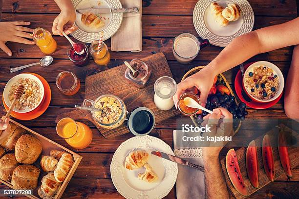 Young Happy Family Having Breakfast Stock Photo - Download Image Now - Breakfast, Family, Preserves