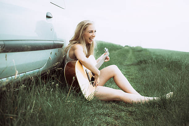 istock Beautiful young woman playing guitar. 537828120
