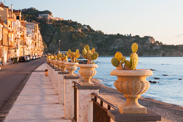 Giardini Naxos View of an ornamental vase with a cactus plant along the seafront of the touristic village Giardini Naxos, Eastsicily giardini naxos stock pictures, royalty-free photos & images