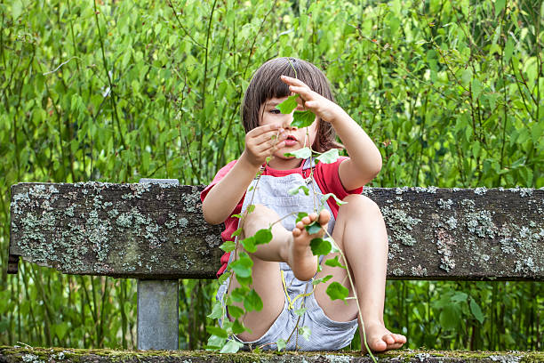 istock boy playing with ivy foliage to learn nature in summertime 537833206