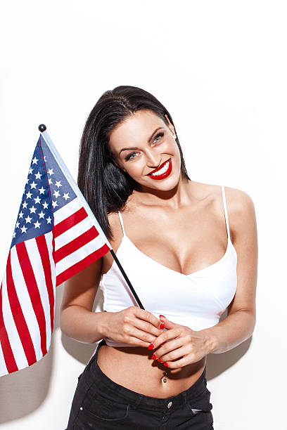 istock Woman posing with small USA flag 537834138