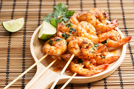 shrimp sriracha kebabs with lime and cilantro leaves