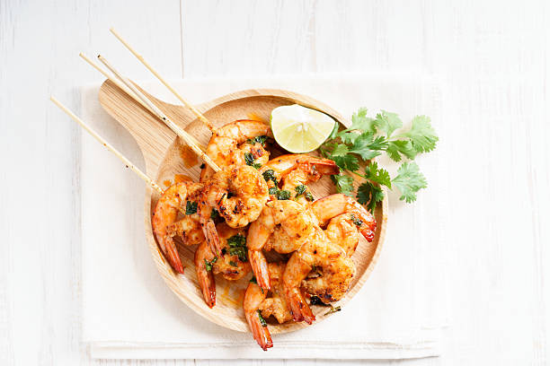 grilled shrimp kababs with sriracha and lime shrimp sriracha kebabs with lime and cilantro leaves skewer photos stock pictures, royalty-free photos & images