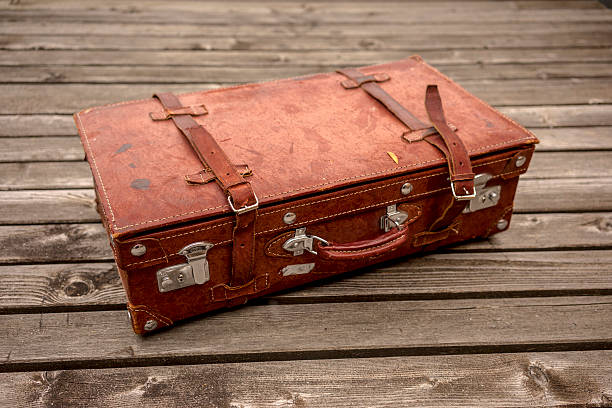Vintage leather suitcase on a wooden deck