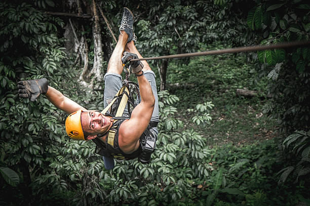 Zipline flight Man zipline flight in jungle zip line stock pictures, royalty-free photos & images