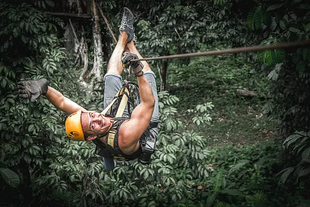 Man zipline flight in jungle