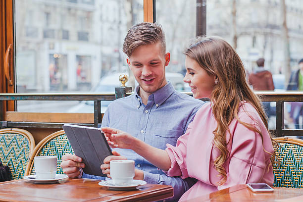 istock couple with digital tablet in cafe, looking at the screen 537841088
