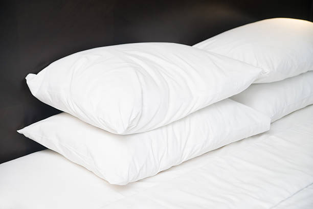 istock Four white pillows on the bed in hotel 537841178
