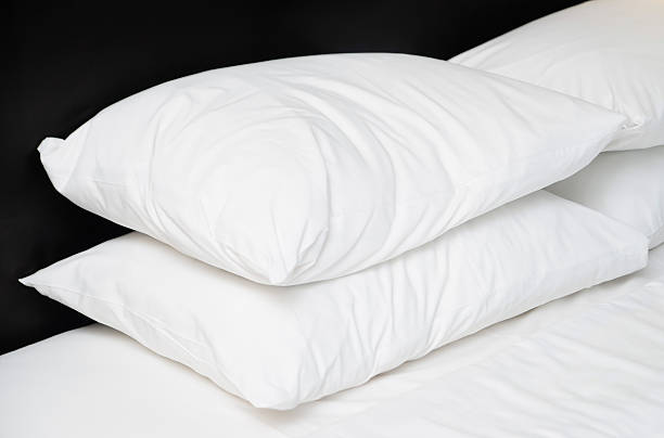 istock Four white pillows on the bed in hotel 537841214