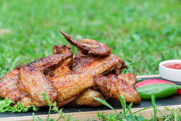 istock Grilled chicken wings in nature on a rock 537841284