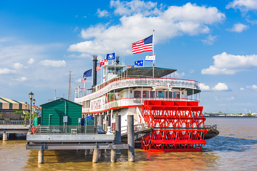 New Orleans, LA, USA - May 10, 2016: The steamboat Natchez at Toulouse Street Wharf on the Mississippi River. The historic vessel currently operates harbor and dinner cruises.