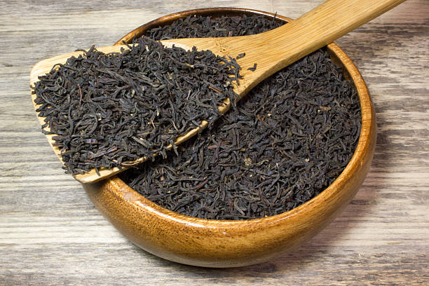 istock Dry tea leaves for black tea and wooden spoon 537844890