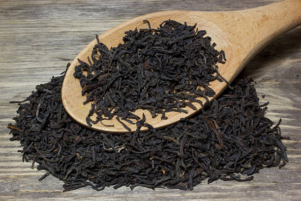 istock Dry tea leaves for black tea and wooden spoon 537845650