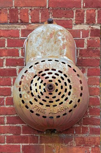 Old Vintage Fire Alarm Bell on Brick Wall