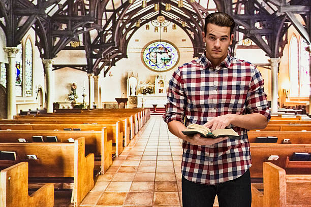 istock Man reading bible in church 537847610