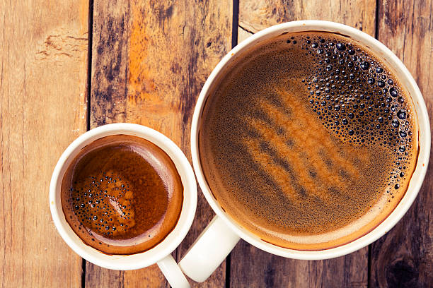 istock Two cups of coffee on timber background, top view 537851134