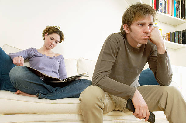 istock Man Watching TV With Woman Reading Magazine 537851779