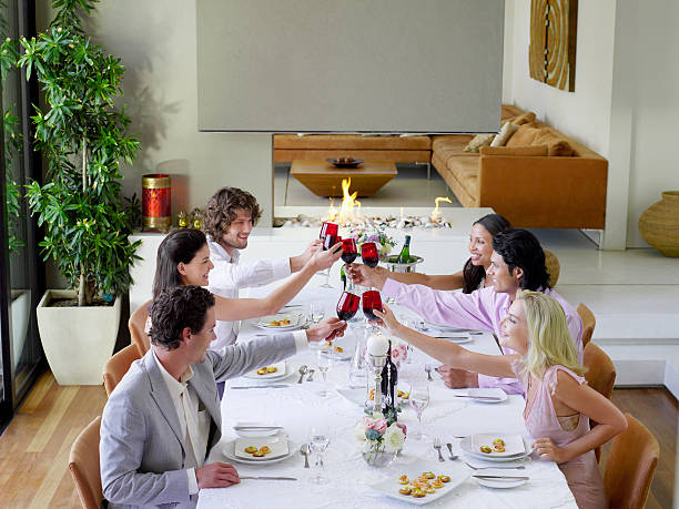 istock Friends Toasting Wineglasses Across Dinner Table 537854035