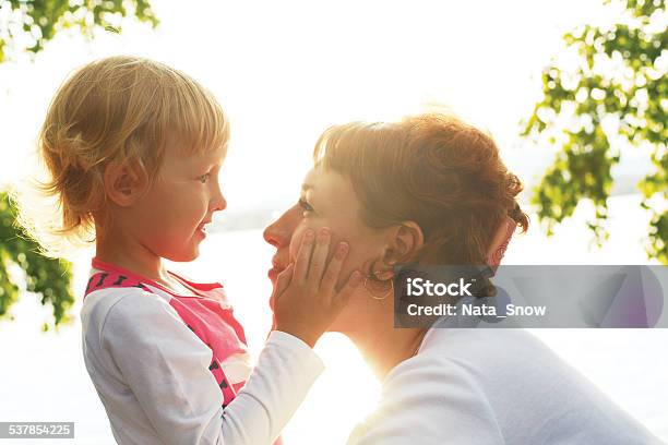Mom Is Looking Lovingly At Her Daughter Stock Photo - Download Image Now - 2015, Adult, Beautiful People