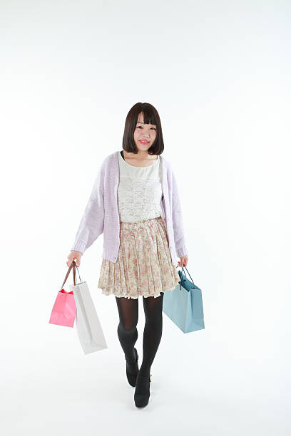 Woman having a paper sack The woman who goes home after shopping. asian women in stockings stock pictures, royalty-free photos & images