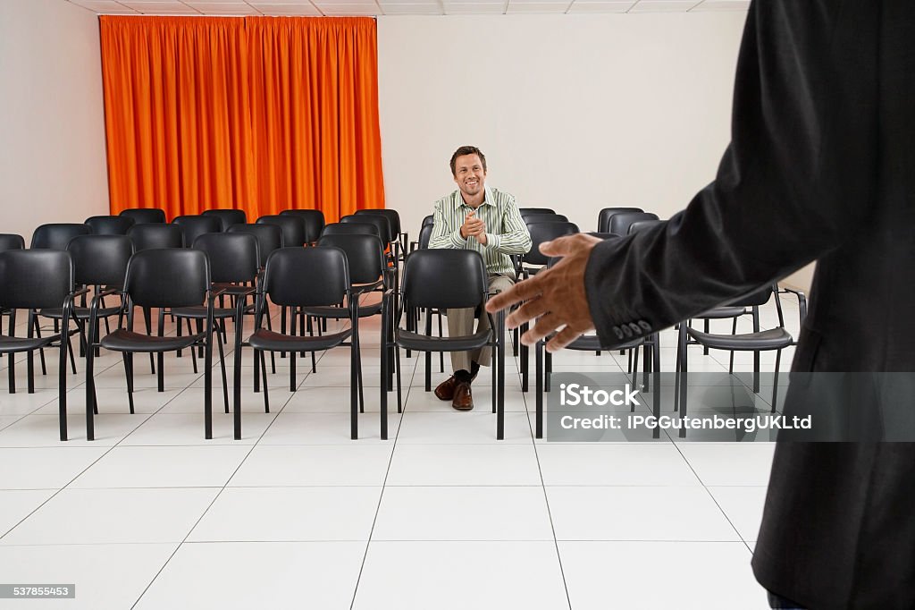 Man Applauding In Conference Room Single smiling man applauding seminar in conference room 2015 Stock Photo