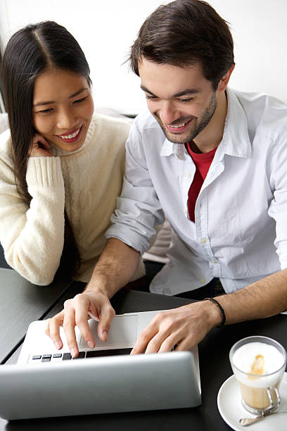 istock Cute happy couple working on laptop 537856709