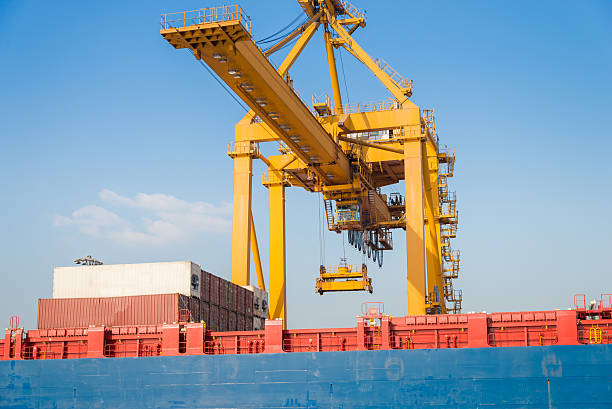 Industrial Container Cargo freight shipping by crane Logistic Import Export  in shipyard at twilight